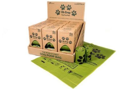Oh Crap compostable cornstarch dog poop bags retail display carton with individual 60-bag boxes, rolls, and green bags